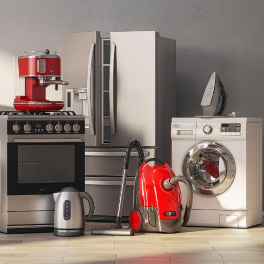 A group of home appliances: a stainless steel refrigerator and oven, red espresso machine, silver kettle, red vacuum cleaner, white washing machine, and iron.