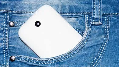 cell phone in white case in jean pocket