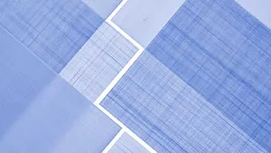Abstract geometric pattern of diagonal blue and periwinkle rectangles, some with cross-hatched texture and others solid, separated by thin white lines.